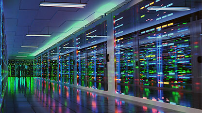Modern server room in data center with three business men in suits standing at the end of a aisle with bright neon lights and reflections