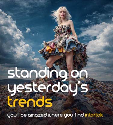 A fashion model standing a pile of old clothes